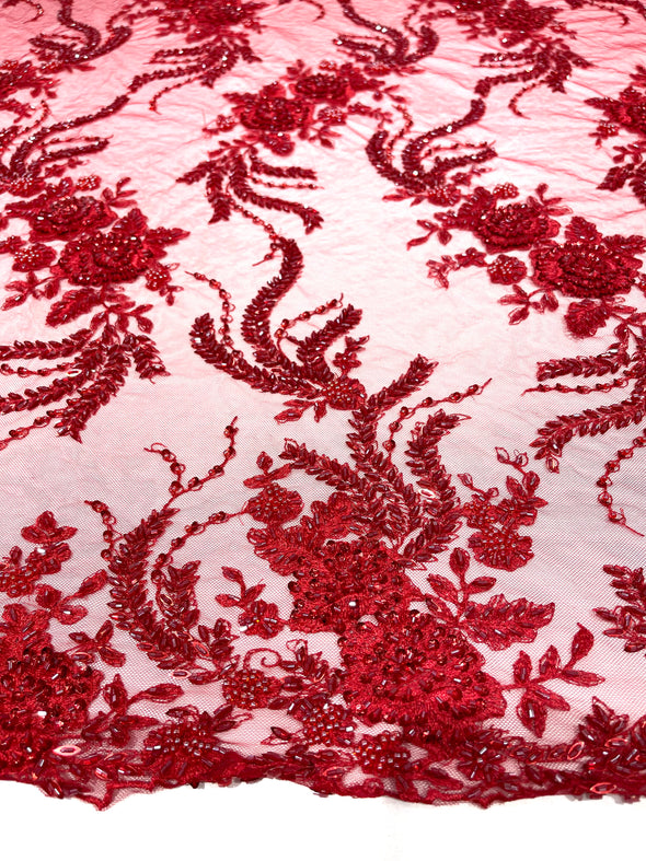 Red flowers embroider and heavy beaded on a mesh lace fabric-sold by the yard.