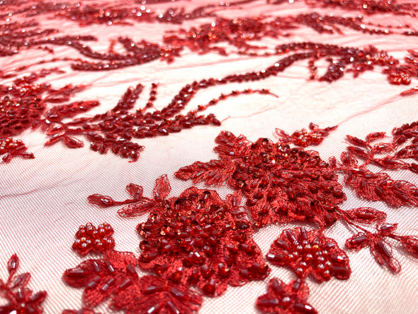 Red flowers embroider and heavy beaded on a mesh lace fabric-sold by the yard.