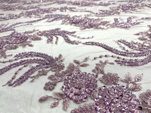 Mauve flowers embroider and heavy beaded on a mesh lace fabric-sold by the yard.