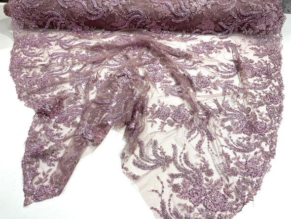 Mauve flowers embroider and heavy beaded on a mesh lace fabric-sold by the yard.