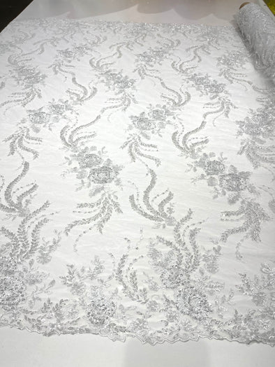 White flowers embroider and heavy beaded on a mesh lace fabric-sold by the yard.