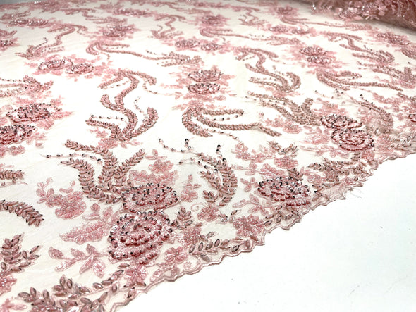 Pink flowers embroider and heavy beaded on a mesh lace fabric-sold by the yard.