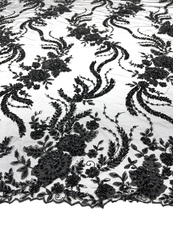 Black flowers embroider and heavy beaded on a mesh lace fabric-sold by the yard.