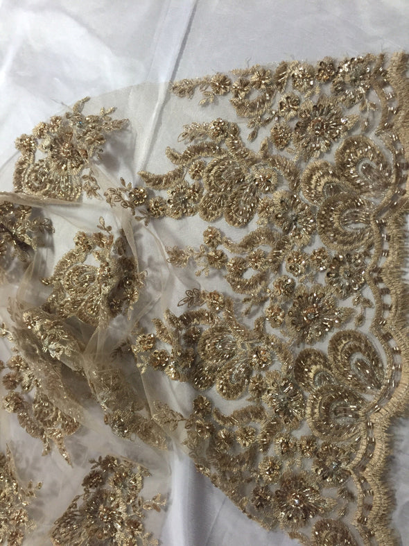 Metallic gold flowers embroider and heavy beaded on a mesh lace fabric-sold by the yard-