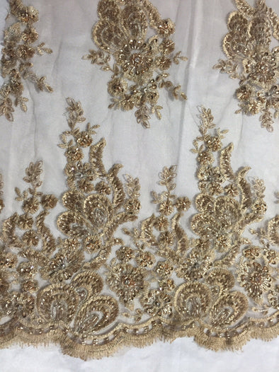 Metallic gold flowers embroider and heavy beaded on a mesh lace fabric-Sold by the yard.