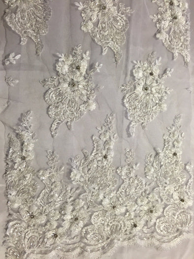 White flowers embroider and heavy beaded on a mesh lace fabric-sold by the yard-