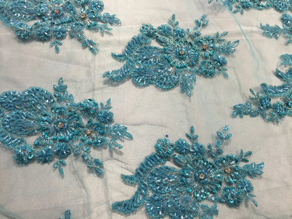 Aqua flowers embroider and heavy beaded on a mesh lace fabric-sold by the yard-