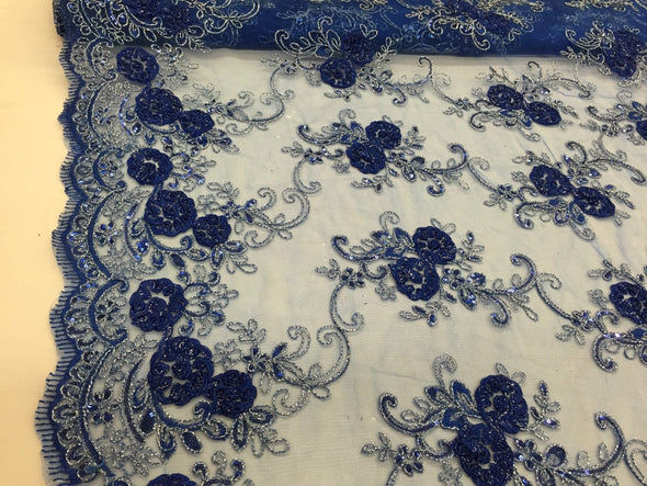 Royal blue/silver 3d flowers embroider with sequins on a royal blue mesh lace. Wedding/bridal/prom/nightgown fabric. Sold by the yard.