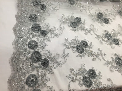 Gray/silver 3d flowers embroider with sequins on a silver mesh lace. Wedding/bridal/prom/nightgown fabric. Sold by the yard.