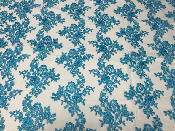 Turquoise modern roses embroider and corded on a mesh lace -yard