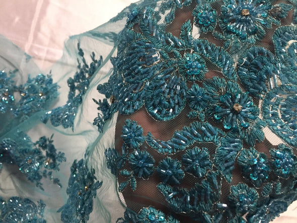 Aqua flowers embroider and heavy beaded on a mesh lace fabric-sold by the yard-