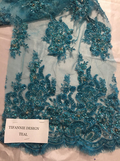 Teal Flowers embroider and heavy beaded on a mesh lace fabric-Sold by the yard.