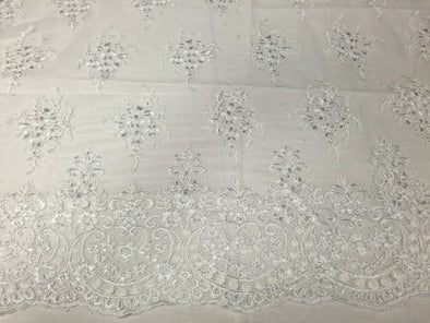 White Royal flowers design embroider with sequins and corded on a mesh lace-yard
