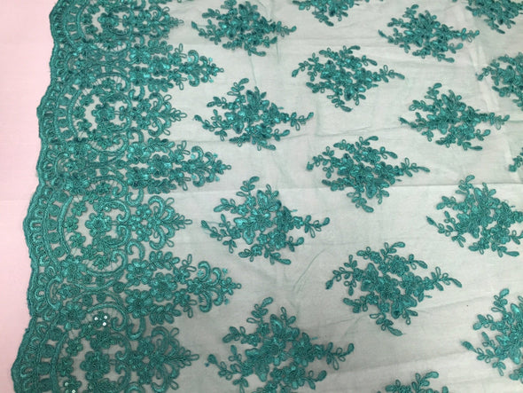 Teal royal flower design embroider with sequins and corded on a mesh lace-yard