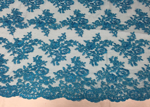 Turquoise modern roses embroider and corded on a mesh lace -yard