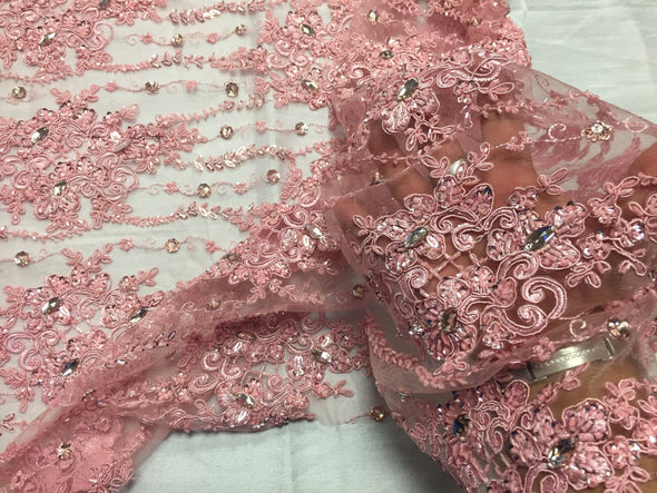Pink magnificant design emrboider and heavy beaded on a mesh lace -yard