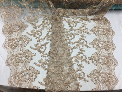 Majestic old gold shinny vine design embroider and heavy beaded on a mesh lace-prom-nightgown-decorations-dresses-sold by the yard.