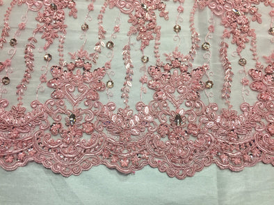 Pink magnificant design emrboider and heavy beaded on a mesh lace -yard