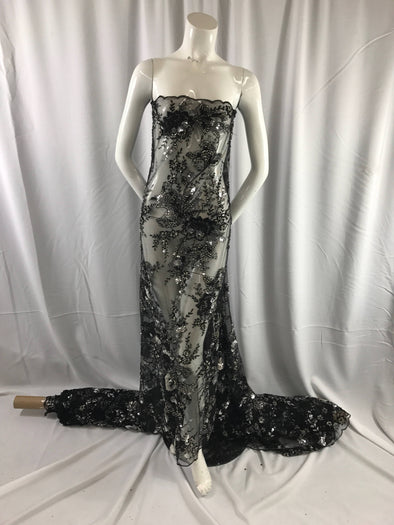 Black mesh embroider with multi color flowers and hand beaded with silver sequins and big beads. Wedding- bridal- prom dresses-sold by yard.