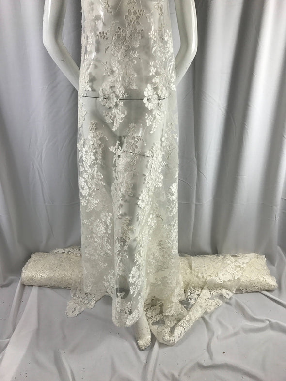 Ivory floral design embroider and corded on a mesh lace fabric-prom-nightgown-decorations-fashion-apparel-dresses-sold by the yard.