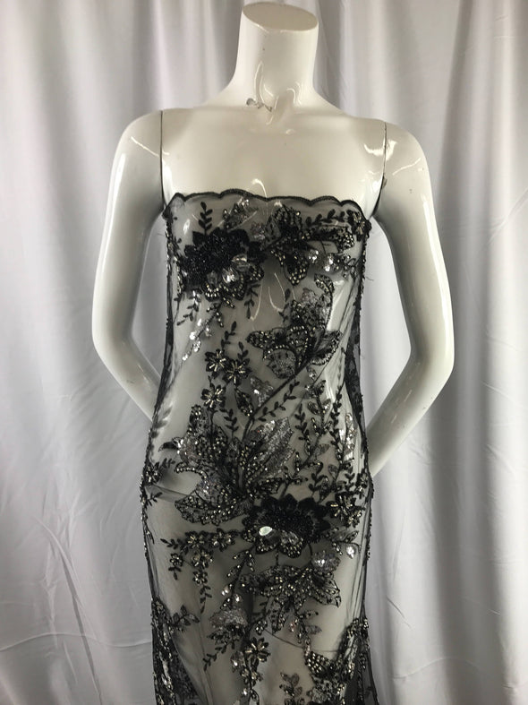 Black mesh embroider with multi color flowers and hand beaded with silver sequins and big beads. Wedding- bridal- prom dresses-sold by yard.