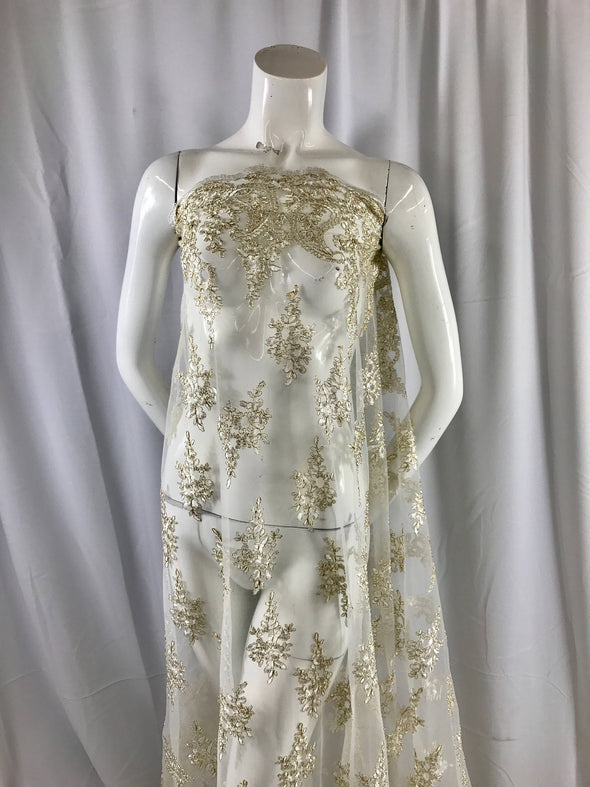 Ivory paisly flower enbroider and corded with metallic gold tread on a mesh lace-wedding-bridal-prom-nightgown-dresses-sold by the yard.