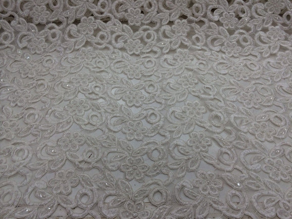 Ivory flowers embroider and hand beaded organza lace.36x50inches. Sold by the yard.