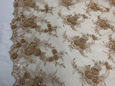 Nude Metallic Gold Flowers French design embroider and hand beaded on a mesh lace. Sold by the yard