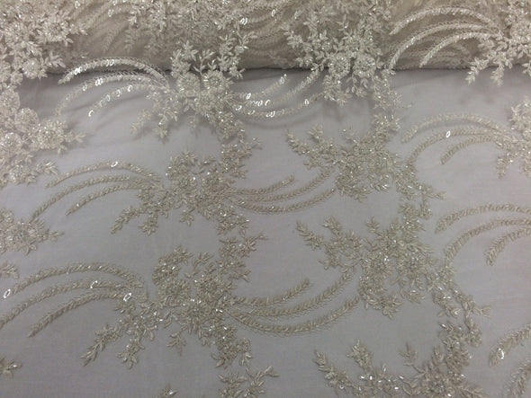 Ivory french design embroidered and heavy beaded on a mesh lace.36x50inches. Wedding-Bridal fabric lace. Sold by the yard.