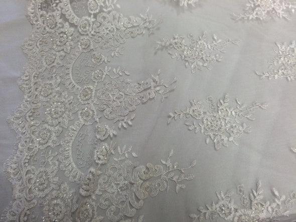 White flower french design embroider and hand beaded on a mesh lace. Wedding-bridal fabric lace.36x50inches. Sold by the yard.