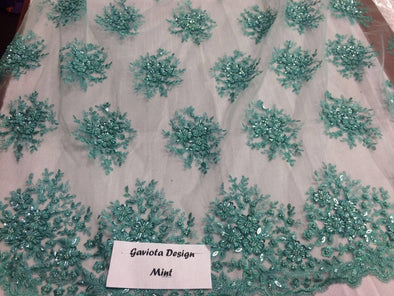 Mint gaviota design embroider and beaded on a mesh lace. Wedding/Bridal/prom/nightgown fabric. Sold by the yard.