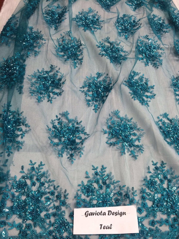 Teal green gaviota design embroider and beaded on a mesh lace. Wedding/Bridal/prom/nightgown fabric. Sold by the yard.