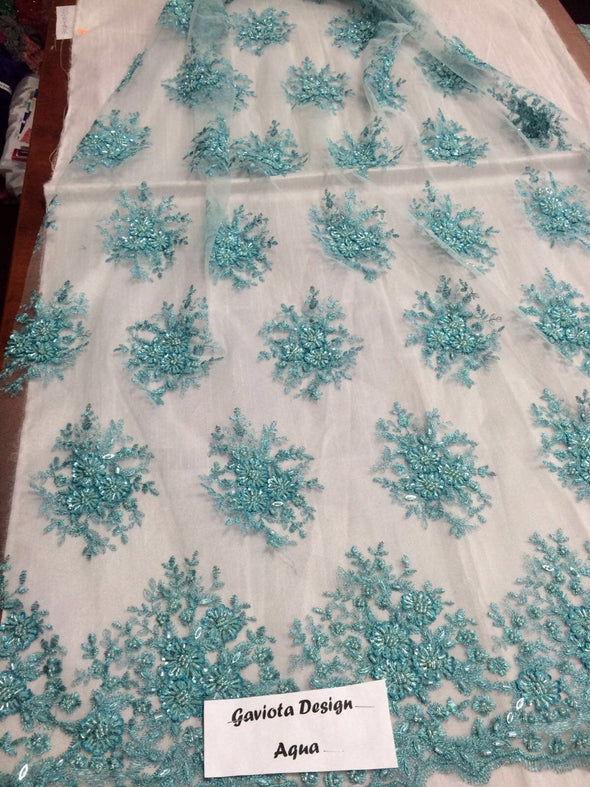 Aqua gaviota design embroider and beaded on a mesh lace. Wedding/Bridal/Prom/Nightgown fabric. Sold by the yard.