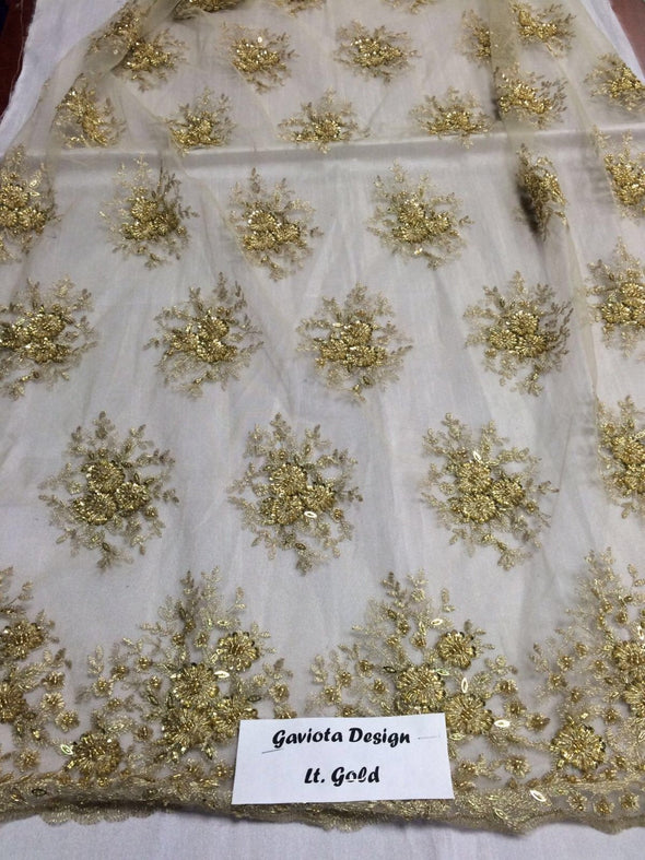 Lt.gold gaviota design embroider and beaded on a mesh lace. Wedding/Bridal/Nightgown/Prom fabric. Sold by the yard.
