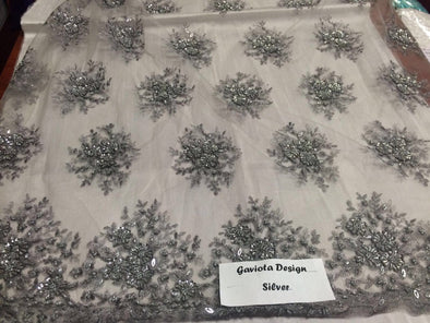 Gray/silver gaviota design embroider and beaded on a mesh lace. Wedding/Bridal/Prom/Nightgown fabric. Sold by the yard.