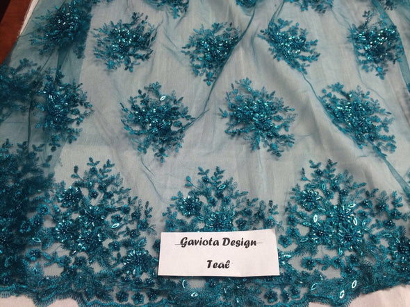 Teal green gaviota design embroider and beaded on a mesh lace. Wedding/Bridal/prom/nightgown fabric. Sold by the yard.
