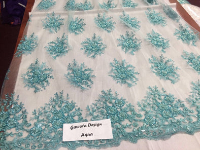 Aqua gaviota design embroider and beaded on a mesh lace. Wedding/Bridal/Prom/Nightgown fabric. Sold by the yard.