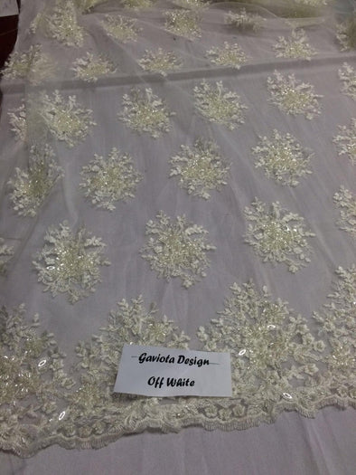 Ivory gaviota design embroider and beaded on a mesh lace. Wedding/Bridal/Prom/Nightgown fabric. Sold by the yard.