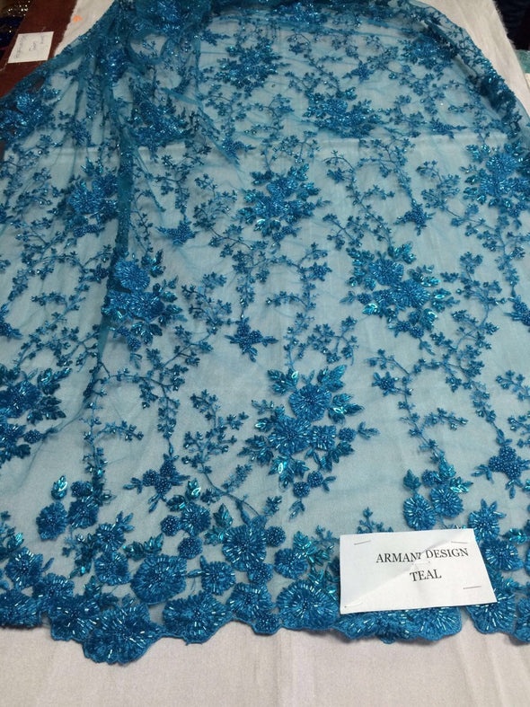 Gorgeous teal blue flower design embroider and beaded on a mesh lace. Wedding/Bridal/Prom/Nightgown fabric. Sold by the yard.