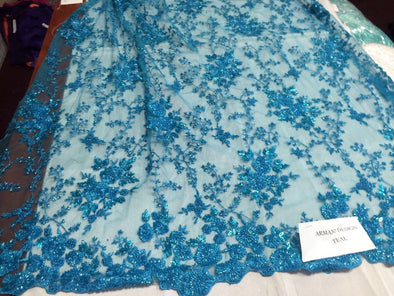 Gorgeous teal blue flower design embroider and beaded on a mesh lace. Wedding/Bridal/Prom/Nightgown fabric. Sold by the yard.